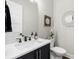 Modern half bathroom with stylish vanity, decorative mirror, and clean design elements at 4806 W San Rafael St, Tampa, FL 33629