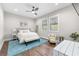 Bedroom featuring hardwood floors, white walls, a ceiling fan and large windows at 4806 W San Rafael St, Tampa, FL 33629