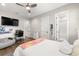 Bright bedroom with ceiling fan, desk, and ensuite bathroom access at 4806 W San Rafael St, Tampa, FL 33629