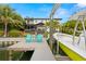 Waterfront home featuring a private dock with boat lift and seating area, showcasing the waterfront lifestyle at 4806 W San Rafael St, Tampa, FL 33629