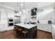 Bright kitchen featuring white cabinets, an island, and stainless steel appliances at 4806 W San Rafael St, Tampa, FL 33629