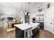Open concept kitchen with island seating, stainless appliances, and adjacent dining/living area at 4806 W San Rafael St, Tampa, FL 33629