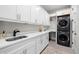 Bright laundry room with modern appliances, ample counter space, and white cabinets at 4806 W San Rafael St, Tampa, FL 33629