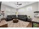 Spacious living room featuring a large sectional sofa, ceiling fan and lots of natural light at 4806 W San Rafael St, Tampa, FL 33629