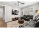 Comfortable living room with sectional sofa, entertainment center, and hardwood floors at 4806 W San Rafael St, Tampa, FL 33629