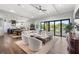 Spacious living room with kitchen, comfortable seating and water views through sliding glass doors at 4806 W San Rafael St, Tampa, FL 33629