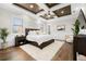 Relaxing main bedroom featuring a tray ceiling, hardwood floors, and a large bed at 4806 W San Rafael St, Tampa, FL 33629
