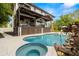 Beautiful outdoor pool and spa with a covered lanai and lush landscaping at 4806 W San Rafael St, Tampa, FL 33629