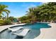 Resort-style pool with integrated loungers, lush landscaping, and a spa at 4806 W San Rafael St, Tampa, FL 33629