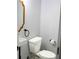 Powder room with modern fixtures, a sink, and toilet at 4954 Cardinal Trl, Palm Harbor, FL 34683