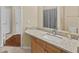 Bathroom vanity with a square white sink, granite countertops, and wood cabinets offers both style and functionality at 5125 Palm Springs Blvd # 11306, Tampa, FL 33647