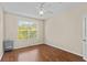 Bright bedroom with hardwood floors and a ceiling fan overlooking a window with natural light at 5125 Palm Springs Blvd # 11306, Tampa, FL 33647