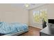 Cozy bedroom featuring hardwood floors and a window offering natural light at 5125 Palm Springs Blvd # 11306, Tampa, FL 33647