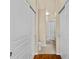 Hallway with a bathroom including white sliding doors and hardwood floors at 5125 Palm Springs Blvd # 11306, Tampa, FL 33647