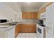 Well-equipped kitchen with granite countertops, white appliances, and ample cabinet space at 5125 Palm Springs Blvd # 11306, Tampa, FL 33647