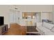 Cozy living room with hardwood floors and a view into the adjacent kitchen area at 5125 Palm Springs Blvd # 11306, Tampa, FL 33647