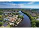 Scenic aerial view of canal-front homes, surrounded by verdant trees and serene waterways at 6208 Imperial Ky, Tampa, FL 33615