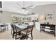 Light-filled dining area showcasing a large table with seating, modern fan and kitchen view at 6208 Imperial Ky, Tampa, FL 33615