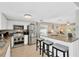 Kitchen with granite countertops, stainless steel appliances, bar stool seating and white cabinetry at 6208 Imperial Ky, Tampa, FL 33615