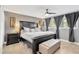Bedroom featuring a dark wood bed frame with neutral decor, large windows and ceiling fan at 6208 Imperial Ky, Tampa, FL 33615