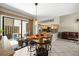 Bright dining area features unique wood table, modern pendant light, and sliding glass doors to the outdoor patio at 6262 142Nd N Ave # 1304, Clearwater, FL 33760