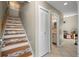 Hallway featuring stairs with decorative mosaic accents, and access to the bathroom at 6262 142Nd N Ave # 1304, Clearwater, FL 33760