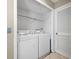 Convenient laundry room with a washer, dryer, and storage shelf, offering practicality and functionality at 6262 142Nd N Ave # 1304, Clearwater, FL 33760