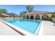 Exterior shot of the community swimming pool showing bright blue water and a covered poolside lounge area at 6262 142Nd N Ave # 1304, Clearwater, FL 33760