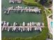 Aerial view of a boat dock with boats docked in a calm harbor, with tropical trees and landscaping at 7862 Sailboat Key S Blvd # 103, South Pasadena, FL 33707