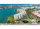 Aerial view showcases the stunning waterfront condo with manicured grounds, lush landscaping, and a serene pond at 7862 Sailboat Key S Blvd # 103, South Pasadena, FL 33707