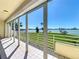 Balcony with sliding glass doors offers stunning views of the green space, bay and beyond at 7862 Sailboat Key S Blvd # 103, South Pasadena, FL 33707