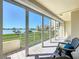 Balcony with seating features a beautiful view of the bay, lush landscaping and serene surrounding at 7862 Sailboat Key S Blvd # 103, South Pasadena, FL 33707
