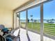 Balcony with lounge chairs and lush greenery provides a serene and comfortable outdoor living experience at 7862 Sailboat Key S Blvd # 103, South Pasadena, FL 33707
