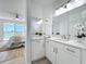 Bathroom with a modern single vanity and a view of the bedroom with a balcony at 7862 Sailboat Key S Blvd # 103, South Pasadena, FL 33707