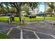 Community car washing and vacuuming station with covered parking, lush landscaping, and mature trees at 7862 Sailboat Key S Blvd # 103, South Pasadena, FL 33707