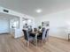 Dining room with modern furnishings, open to the kitchen, and wood-look flooring at 7862 Sailboat Key S Blvd # 103, South Pasadena, FL 33707