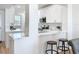 Modern kitchen featuring white cabinets, quartz countertops, and a breakfast bar at 7862 Sailboat Key S Blvd # 103, South Pasadena, FL 33707