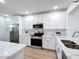 Bright kitchen featuring white cabinets, stainless steel appliances, and quartz countertops at 7862 Sailboat Key S Blvd # 103, South Pasadena, FL 33707