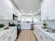 Modern kitchen boasts white cabinets, stainless steel appliances, and an open layout to the living area at 7862 Sailboat Key S Blvd # 103, South Pasadena, FL 33707