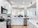 Modern kitchen boasts white cabinets, stainless steel appliances, and an open layout to the living area at 7862 Sailboat Key S Blvd # 103, South Pasadena, FL 33707