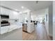 Modern kitchen boasts white cabinets, stainless steel appliances, and an open layout to the dining and living area at 7862 Sailboat Key S Blvd # 103, South Pasadena, FL 33707