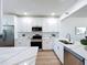 Bright kitchen featuring white cabinets, stainless steel appliances, and quartz countertops at 7862 Sailboat Key S Blvd # 103, South Pasadena, FL 33707