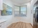 Bright corner of the kitchen features white cabinets, stainless steel appliances, and a window at 7862 Sailboat Key S Blvd # 103, South Pasadena, FL 33707