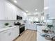 Modern kitchen boasts white cabinets, stainless steel appliances, and an open layout to the living area at 7862 Sailboat Key S Blvd # 103, South Pasadena, FL 33707