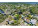 An aerial view of a residential neighborhood featuring a home with a private pool and a fenced backyard at 8205 Overlook Ne Pl, St Petersburg, FL 33702