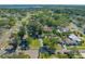 This is an aerial view of a neighborhood showcasing lush landscapes, a private pool, and a home with a detached garage at 8205 Overlook Ne Pl, St Petersburg, FL 33702