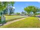 Charming two-story home with a large green lawn, white picket fence, and detached garage at 8205 Overlook Ne Pl, St Petersburg, FL 33702
