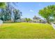 Charming property featuring a well-manicured front lawn, a detached garage, and a classic two-story home with mature trees at 8205 Overlook Ne Pl, St Petersburg, FL 33702