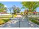 This property features a classic two-story home with a detached garage, complemented by a well-manicured lawn and mature trees at 8205 Overlook Ne Pl, St Petersburg, FL 33702