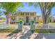 Inviting home exterior with a quaint picket fence, lush greenery, and a welcoming entrance enhanced by decorative planters at 8205 Overlook Ne Pl, St Petersburg, FL 33702